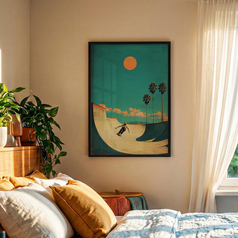 May include: Framed art print featuring a skateboarder in a skatepark bowl under a bright orange sun and palm trees. The background is a teal color, and the print has a vintage aesthetic. The artwork is in a black frame.