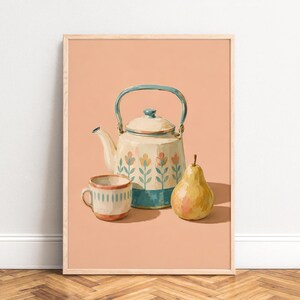 May include: A framed art print featuring a cream-coloured teapot with a teal handle and floral pattern, a matching cream cup with teal vertical stripes, and a yellow pear, all set against a solid peach background within a light wood frame.