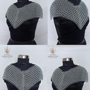 May include: A silver chainmail coif, displayed on a black mannequin. The coif is made of small, interlocking metal rings, designed to protect the neck and shoulders. The Steel Heritage logo is visible in the background.