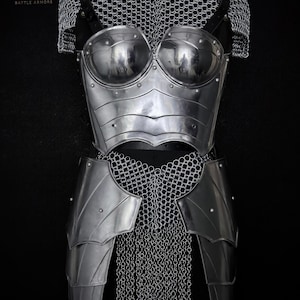 May include: Polished steel battle armour set, comprising a breastplate, shoulder guards, and chainmail. The armour has a reflective surface and is displayed on a black mannequin. The Steel Heritage logo is visible.