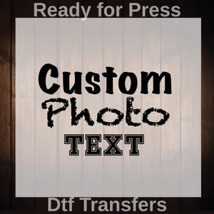 May include: A digital transfer design with the words "Custom Photo TEXT" in black. The text is on a white background with a wood-grain border. The words "Ready for Press" and "Dtf Transfers" are also included.