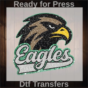 K&ouml;nnte beinhalten: Glitzerndes Adlerkopf-Logo mit dem Wort "Eagles" in einem wei&szlig;en, gr&uuml;nen und schwarzen Design. Der Text "Ready for Press" steht oben und "Dtf Transfers" unten.