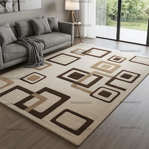 May include: Rectangular beige rug featuring a geometric design of overlapping brown and tan squares. The rug is placed on a wooden floor, with a grey sofa and a lamp visible in the background.