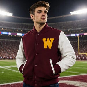 May include: A maroon varsity jacket with white sleeves and a yellow letter W on the chest. The jacket features a snap-button front closure, ribbed cuffs, and two side pockets with white trim, worn over a dark shirt in a stadium setting.
