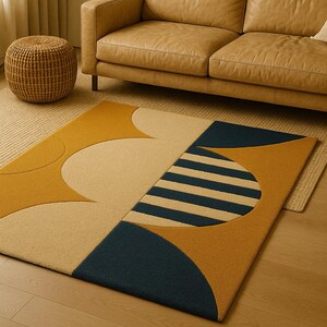 May include: A contemporary rug with a geometric pattern in mustard yellow, cream, and navy blue. The rug is placed on a wooden floor, with a leather sofa and a woven ottoman in the background. The rug's design includes circles and striped sections.