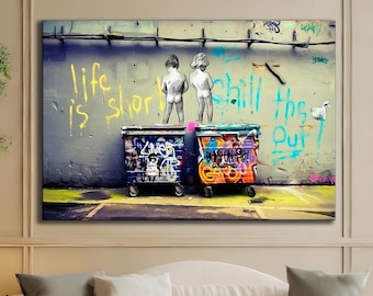 May include: A large framed canvas art piece showing two figures standing on graffiti-covered bins. The artwork features vibrant colours and the text "life is short" and "chill the f*** out". The artwork is displayed above a white sofa.