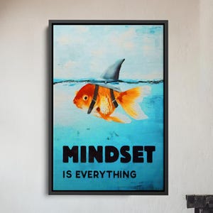 May include: Framed art print featuring a goldfish with a shark fin, set against a blue background. The text "MINDSET IS EVERYTHING" is prominently displayed. The artwork is in a black frame, suitable for home decor.
