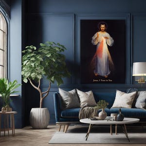 May include: A living room with a blue sofa, a round coffee table, and a large framed artwork depicting a religious figure. A potted tree and a small side table with a plant are also present. The artwork has the text "Jesus, I Trust in You".