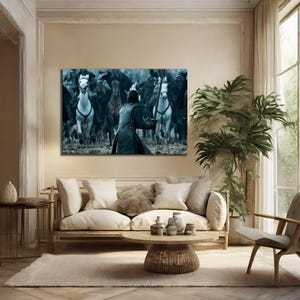 May include: A framed canvas print depicting a battle scene with a figure in the foreground holding a sword, facing a charge of riders on horseback. The horses are in motion, creating a sense of action.