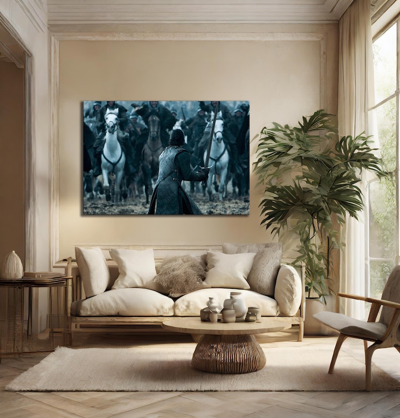 May include: A framed canvas print depicting a battle scene with a figure in the foreground holding a sword, facing a charge of riders on horseback. The horses are in motion, creating a sense of action.