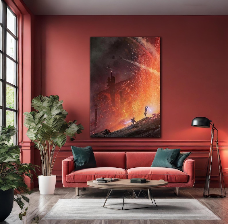 May include: A large framed canvas art print depicting a science fiction scene with two figures wielding lightsabers against a fiery backdrop. The artwork is displayed above a red sofa in a living room setting.