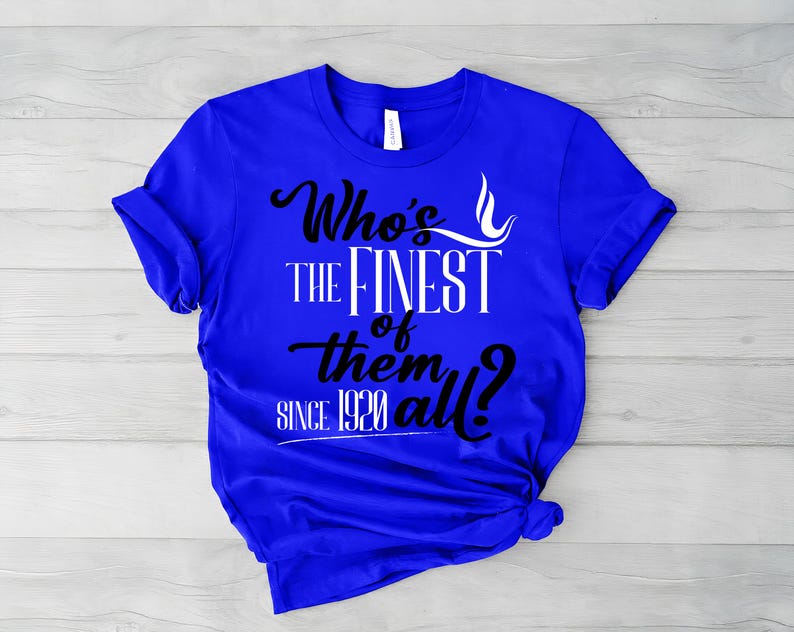 May include: A bright royal blue short-sleeve t-shirt featuring black and white text that reads Who's the finest of them all? since 1920. The shirt has a crew neckline and a small white brand tag visible inside the collar area at the back.