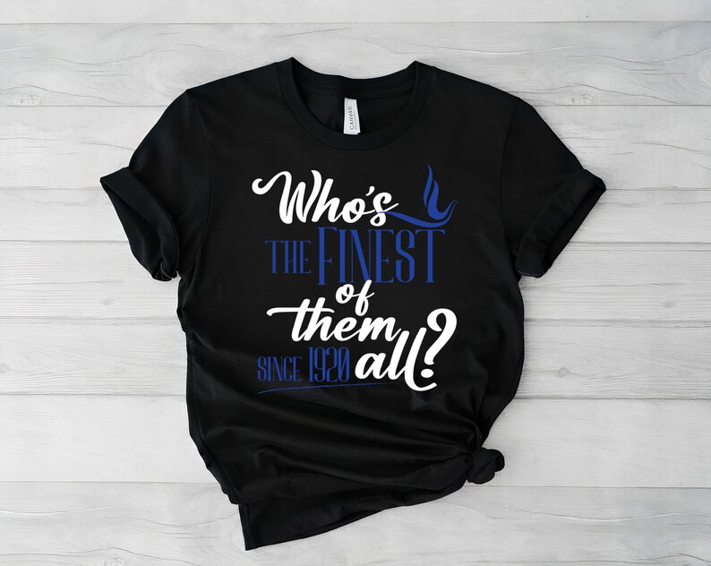 May include: A black short-sleeve t-shirt featuring white and blue text that reads Who's the Finest of them all? since 1920. The design uses a mix of cursive and block lettering, with a small blue flame graphic positioned above the word Finest.