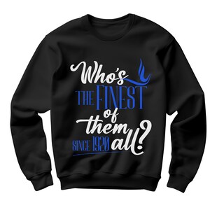 May include: A black long-sleeve sweatshirt featuring white and blue text that reads Who's the finest of them all? since 1920. The design is centered on the chest, utilizing a mix of cursive and block lettering styles against the solid black fabric.