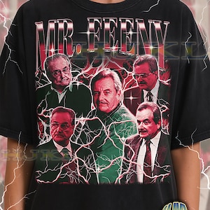 May include: Black adult unisex t-shirt featuring a graphic design with the text "MR. FEENY" above a collage of images of a man. The design has a vintage, distressed look with red and white accents and lightning bolt details.