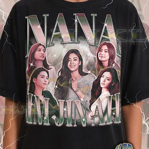 May include: Black adult unisex t-shirt featuring the name "NANA IM JINAH" in a vintage style. The shirt has a graphic of multiple images of a woman. The text "ADULT Unisex Shirt : BLACK" is at the bottom.