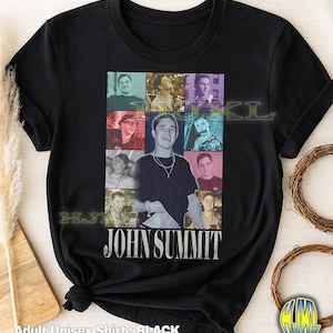 May include: Black adult unisex t-shirt featuring a collage of images of John Summit. The shirt has the text "JOHN SUMMIT" in a white, stylized font. The words "Adult Unisex Shirt: BLACK" are printed at the bottom.