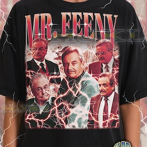 May include: Black adult unisex t-shirt featuring a graphic of Mr. Feeny with a red and white lightning design. The shirt has the text "MR. FEENY" in a red and gold font. The shirt also has the text "ADULT Unisex Shirt : BLACK".