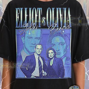 May include: Black adult unisex t-shirt with a blue and white graphic of two people, the text "ELLIOT & OLIVIA", and the names "Stabler" and "Benson". The shirt also has the text "ADULT Unisex Shirt : BLACK".