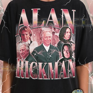 May include: Black adult unisex t-shirt featuring a graphic of Alan Rickman with the text "ALAN RICKMAN" in a red and white font. The shirt has a vintage style design with multiple images of the actor.