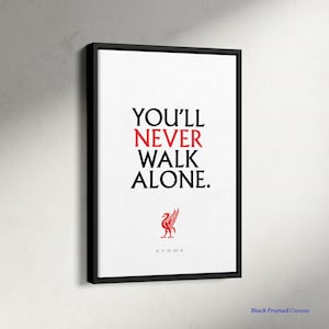 May include: Black framed canvas art with the text "YOU'LL NEVER WALK ALONE" in black and red. A red bird emblem is below the text, with the letters #YNWA below the emblem. The canvas is on a white background.