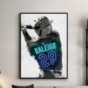 May include: A framed wall art print featuring a black and white watercolor-style illustration of a baseball player swinging a bat. The player wears a jersey with the name RALEIGH and the number 29 in a glowing neon blue outline effect.