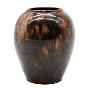 May include: A decorative ceramic vase with a rounded body and a narrow opening. The vase features a dark brown and tan marbled glaze with a floral design etched into the surface. The vase is approximately 10 inches tall.