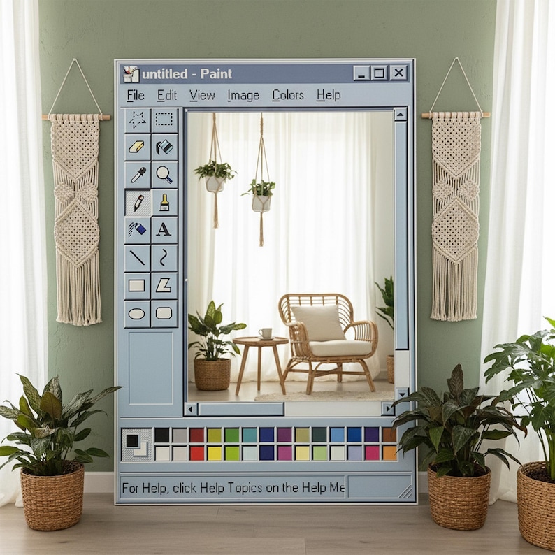 Op de afbeelding: Een grote spiegel ontworpen als een vintage computer paint programma venster. De spiegel heeft een lichtblauw frame met een werkbalk en kleurenpalet. De tekst "untitled - Paint" staat bovenaan. De spiegel reflecteert een kamer met planten en een rotan stoel.
