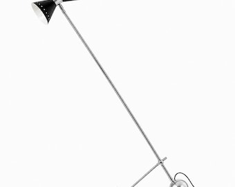 May include: A floor lamp featuring a long, thin, polished chrome metal arm angled upward. At the top, a double-ended black cone-shaped shade with white interiors and small perforations. The base consists of a chrome sphere and a horizontal bar.