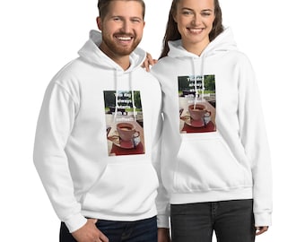 May include: White hooded sweatshirts with the text "The day always starts with a good coffee!!!" printed on the front. The image on the sweatshirt shows a cup of coffee on a saucer.