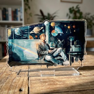 May include: A set of three ceramic mugs with a speckled, matte finish. The mugs are in shades of cream, light gray, and dark gray. Each mug has a simple, minimalist design and a rounded handle.