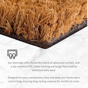 May include: Close-up of a rectangular doormat with a natural fiber surface and a dark border. The doormat is made of tough fibers and a slip-resistant PVC rubber backing. The doormat is designed for easy maintenance.