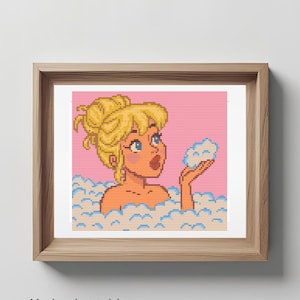 May include: Cross-stitch pattern of a cartoon woman in a bubble bath, holding a cloud of bubbles. The artwork is framed in a wooden frame. Text on the image reads "PDF DIGITAL DOWNLOAD", "No backstitch! Beginner friendly!" and "Piesling stitch face".