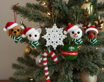 May include: A Christmas tree decorated with handmade crochet ornaments. The ornaments include a dog, cat, snowman, and reindeer, each wearing a Santa hat and scarf. Other ornaments include a snowflake, a candy cane, and a green and red ball.