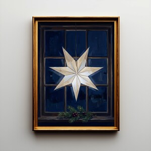 May include: A framed painting depicting a multi-pointed white star ornament hanging in front of a dark blue window pane. Below the star, a small sprig of green pine needles with tiny red berries rests on the window sill. The frame is gold.