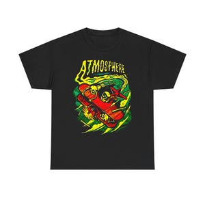 May include: Black t-shirt featuring a colorful graphic of a red airplane with skeleton pilots and the word "ATMOSPHERE" in yellow and green. The design has a vintage, edgy aesthetic.