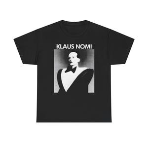 May include: Black t-shirt featuring a black and white image of Klaus Nomi. The image is a portrait of the singer in a tuxedo. The text "KLAUS NOMI" is printed above the portrait in white block letters.