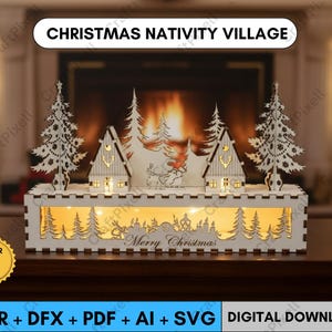 May include: A laser-cut Christmas nativity village scene. The white wooden display features cut-out trees, houses, and a reindeer scene, with the words "Merry Christmas" below. The text "Christmas Nativity Village" is at the top.