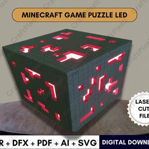 May include: A Minecraft-themed LED puzzle cube with a dark green exterior and red illuminated interior. The cube features cut-out shapes and the text "MINECRAFT GAME PUZZLE LED". The image also includes the text "LASER CUT FILE" and "DIGITAL DOWNLOAD".
