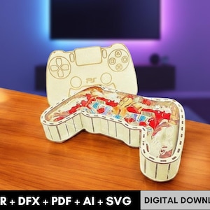 以下が含まれることがあります： カラフルなお菓子で満たされた、ベージュ色の木製PS5コントローラー型の箱。 コントローラーのデザインには、ボタンと方向パッドが含まれています。 下部には「CDR + DFX + PDF + AI + SVG」と「デジタルダウンロード」の文字が見えます。