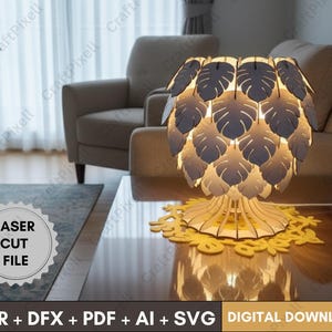 May include: A wooden lamp with a leaf-shaped shade, illuminated from within, sits on a table. The lamp is surrounded by a yellow floral-shaped base. The image also includes the text "LASER CUT FILE" and "CDR + DFX + PDF + AI + SVG DIGITAL DOWNLOAD."