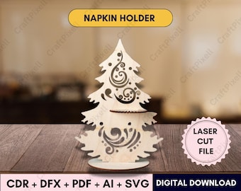 May include: A laser-cut wooden napkin holder in the shape of a Christmas tree. The tree has decorative swirls and cut-out designs. The text "NAPKIN HOLDER" is in a yellow banner above the tree. The image also includes the text "LASER CUT FILE" and "DIGITAL DOWNLOAD".