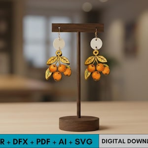 May include: A pair of wooden earrings featuring a design of orange fruit clusters with green leaves and a cream-colored circle at the top. The earrings are displayed on a wooden stand. The text at the bottom says "CDR + DFX + PDF + AI + SVG DIGITAL DOWNLOAD."