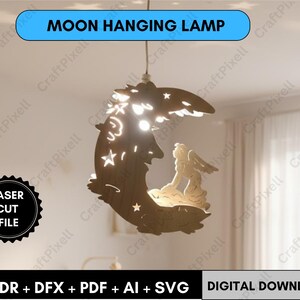 May include: A wooden moon-shaped hanging lamp with star cutouts and an angel silhouette. The lamp is suspended from the ceiling and has the text "MOON HANGING LAMP". The image also includes the text "LASER CUT FILE" and "CDR + DFX + PDF + AI + SVG DIGITAL DOWNLOAD".