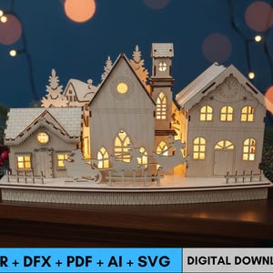 May include: A wooden Christmas village scene with illuminated windows and a reindeer-pulled sleigh. The laser-cut design features several buildings, including a church and houses, with intricate details. The base includes the text "CDR + DFX + PDF + AI + SVG" and "DIGITAL DOWNLOAD".