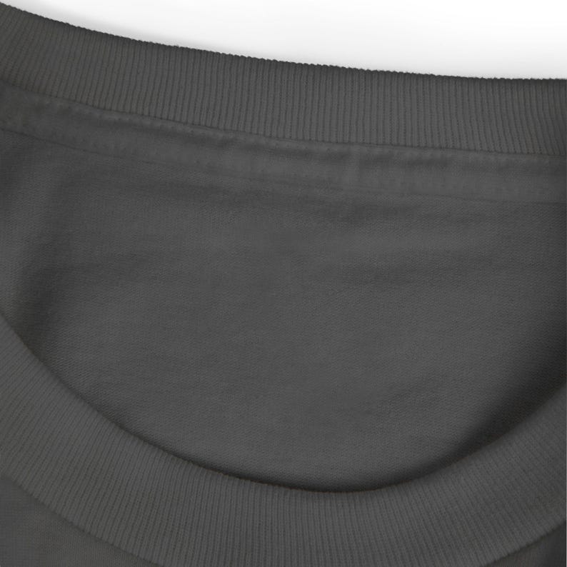 May include: Close-up of a dark gray crew neck sweatshirt. The neckline and collar are ribbed. The fabric appears soft and smooth. The image is well-lit, highlighting the texture and color of the garment.