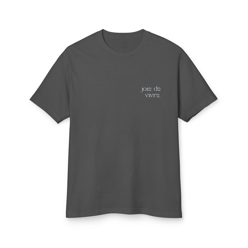May include: Dark gray t-shirt with short sleeves. The shirt has the phrase "joie de vivre" printed in a small, elegant font on the upper right chest area. The shirt is made of a soft material and is suitable for casual wear.