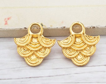 May include: Two gold-tone metal earring charms with a scalloped design. Each charm has a small loop at the top for attaching to earrings.