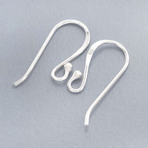 May include: Two silver earring hooks with a small ball at the end of each hook.