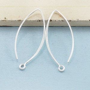 May include: Two silver earring hooks, each with a loop at the end. The hooks are made of thin, smooth metal and are designed to be used with a variety of earring styles.